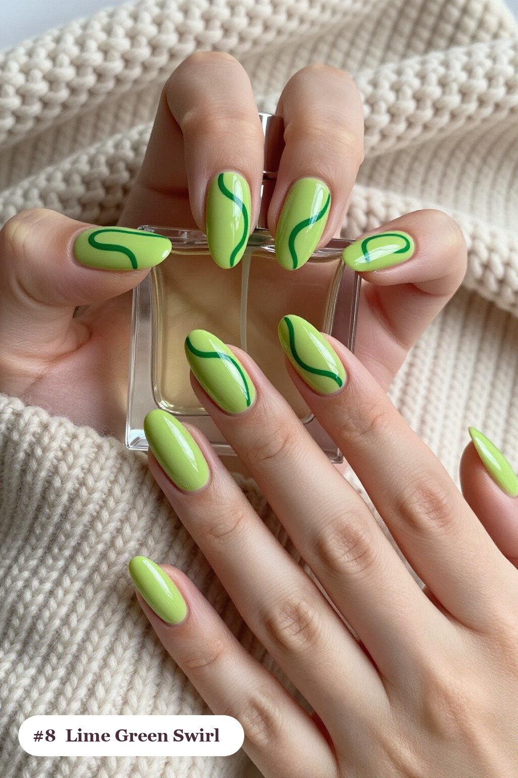 Medium almond lime green nails with bold hand-painted swirl lines flowing across every nail in a contrasting colour, perfect for halloween - halloween almond nails