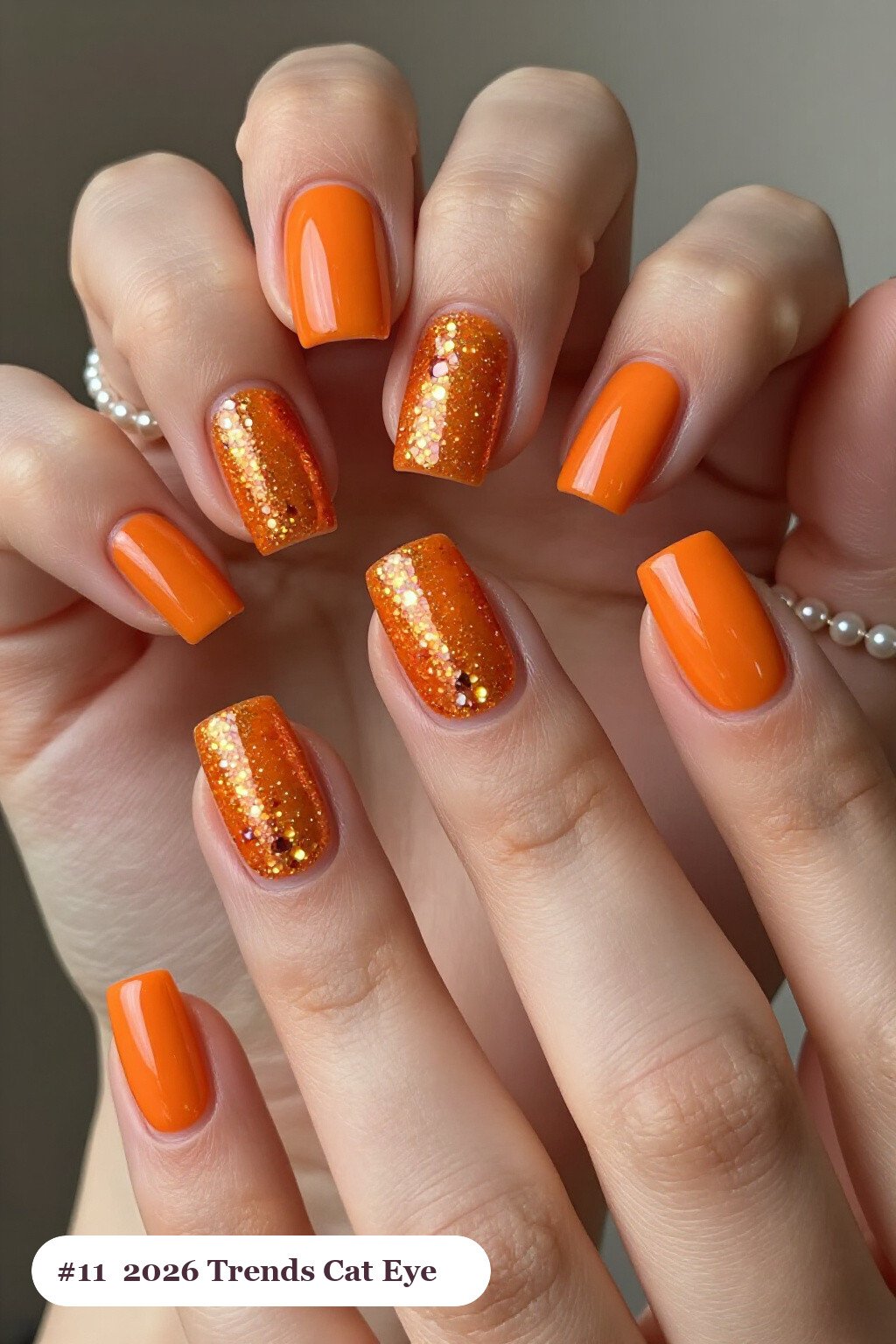 Orange Short Squares Glowing with a Center Gemstone Shimmer Band - halloween nails 2026 trends