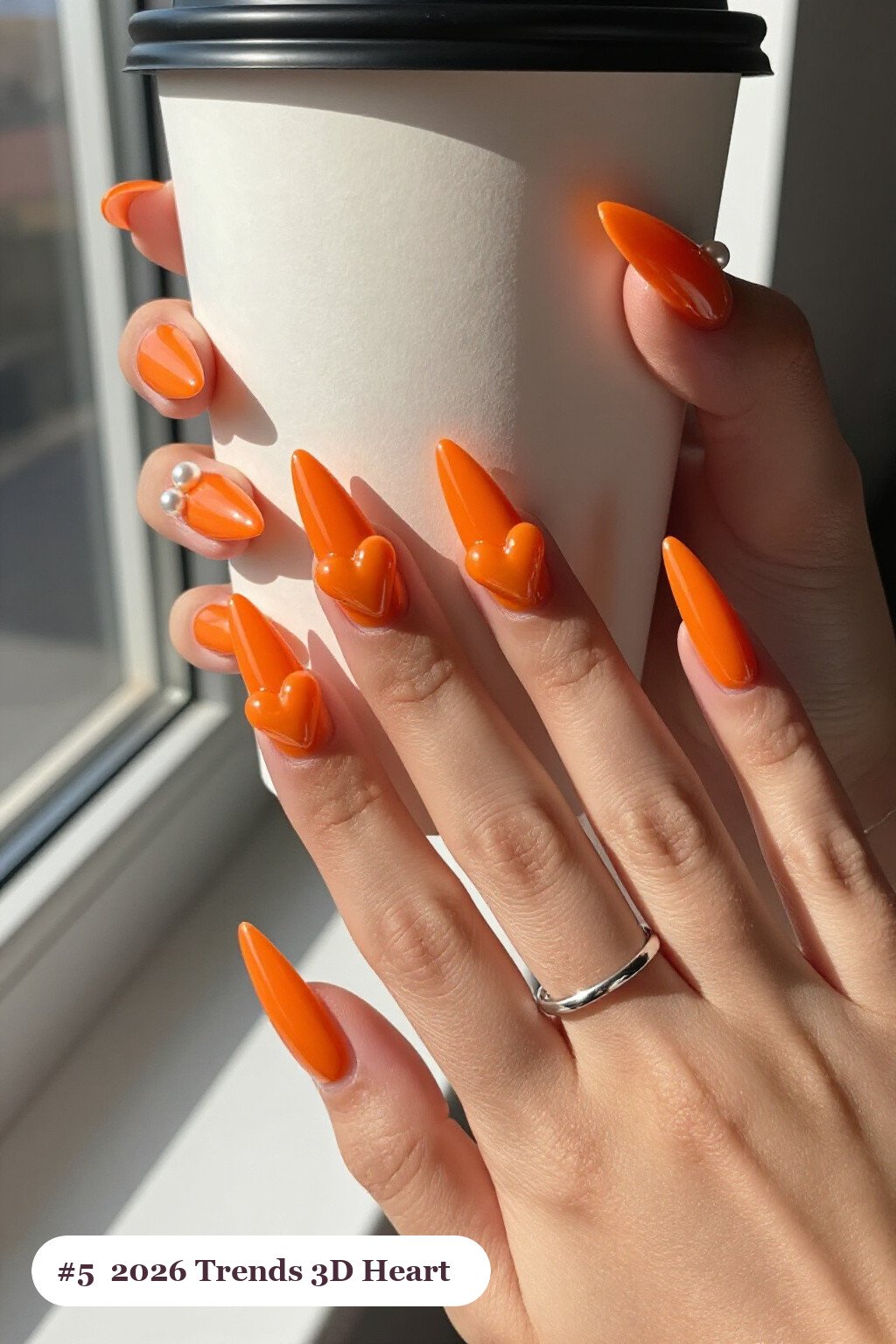 Orange Stilettos Featuring Chunky 3D Gel Hearts and Pearls - halloween nails 2026 trends