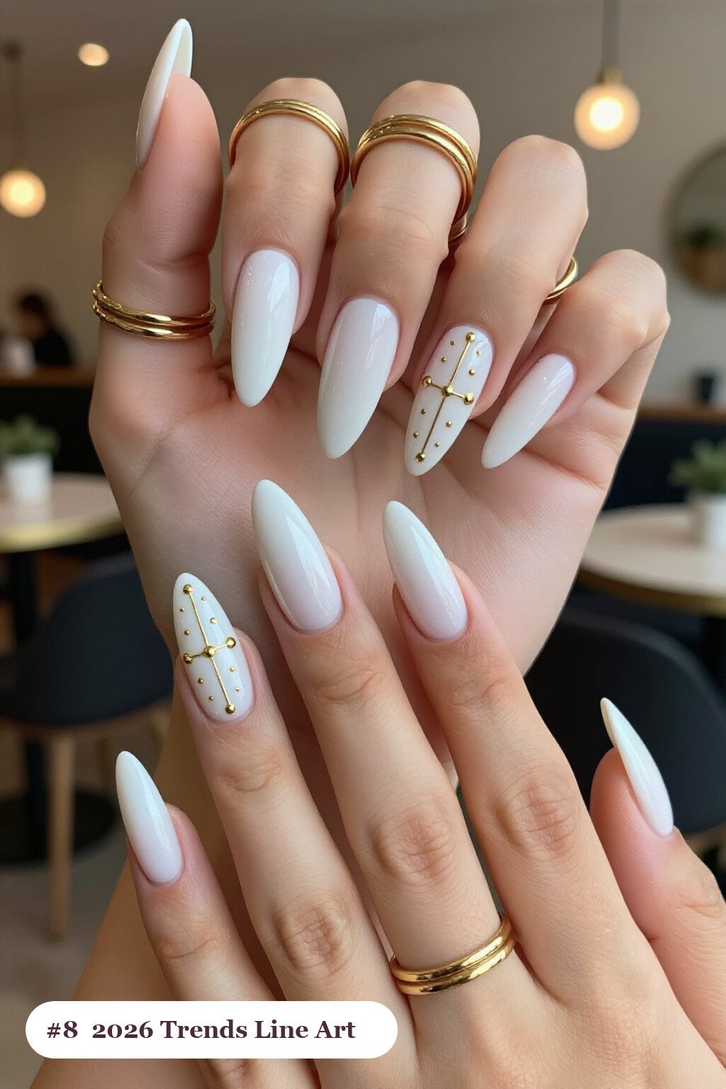 Bone‑White Almonds Adorned with Fine Gold Line Art and Tiny Dots - halloween nails 2026 trends