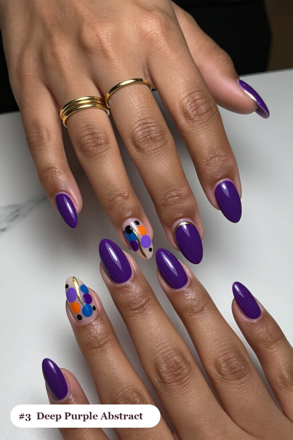 Medium almond deep purple nails with abstract art of colour blobs, gold outlines and dots, perfect for halloween - halloween nails
