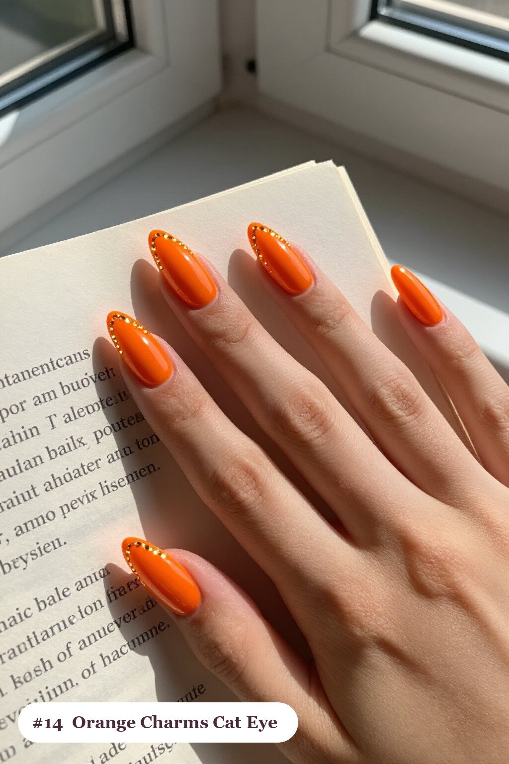 Long coffin orange charms nails with a glowing shimmer band of light running down the centre of each nail like a gemstone, perfect for halloween - halloween nails with charms