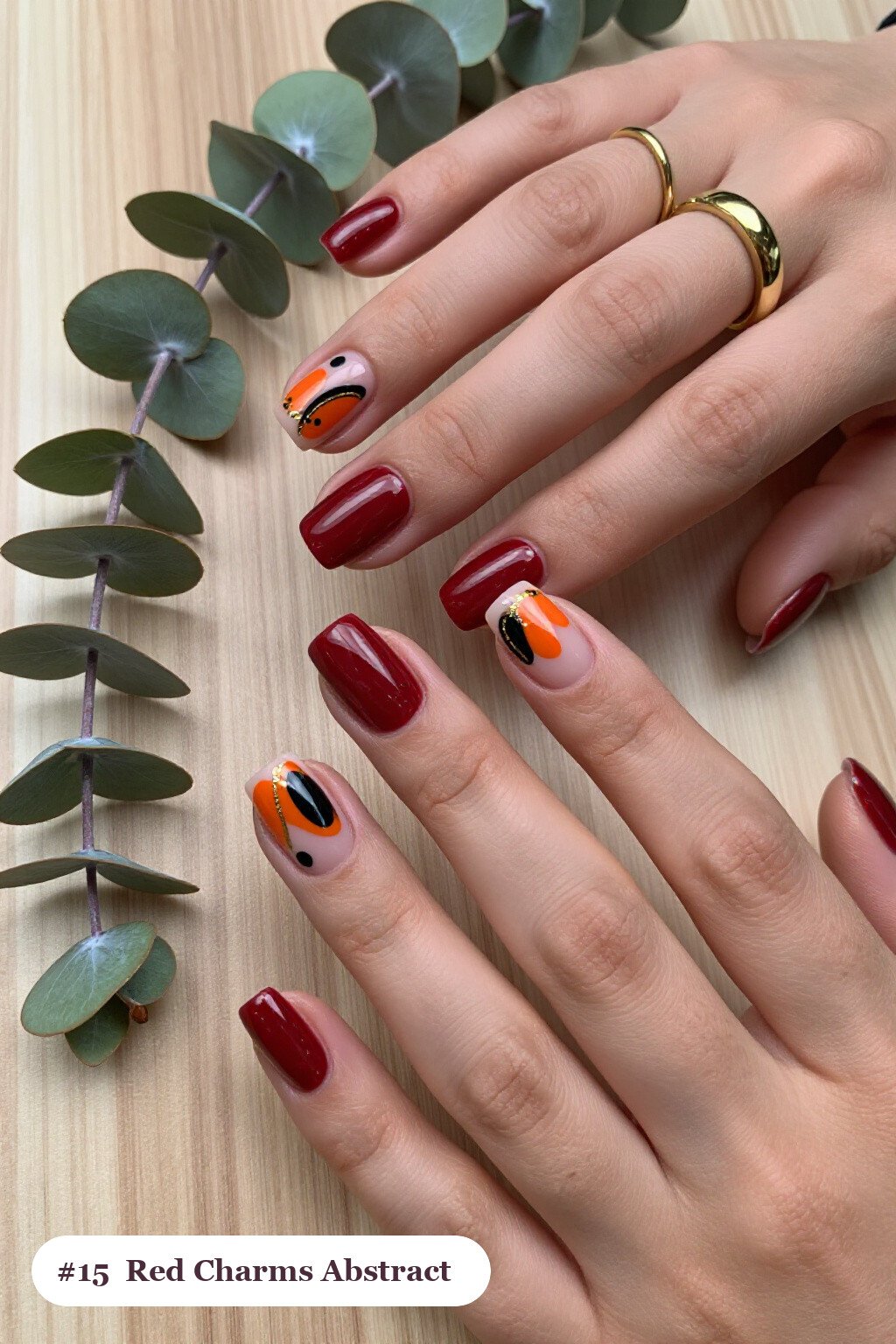 Short square blood red charms nails with abstract art of colour blobs, gold outlines and dots, perfect for halloween - halloween nails with charms