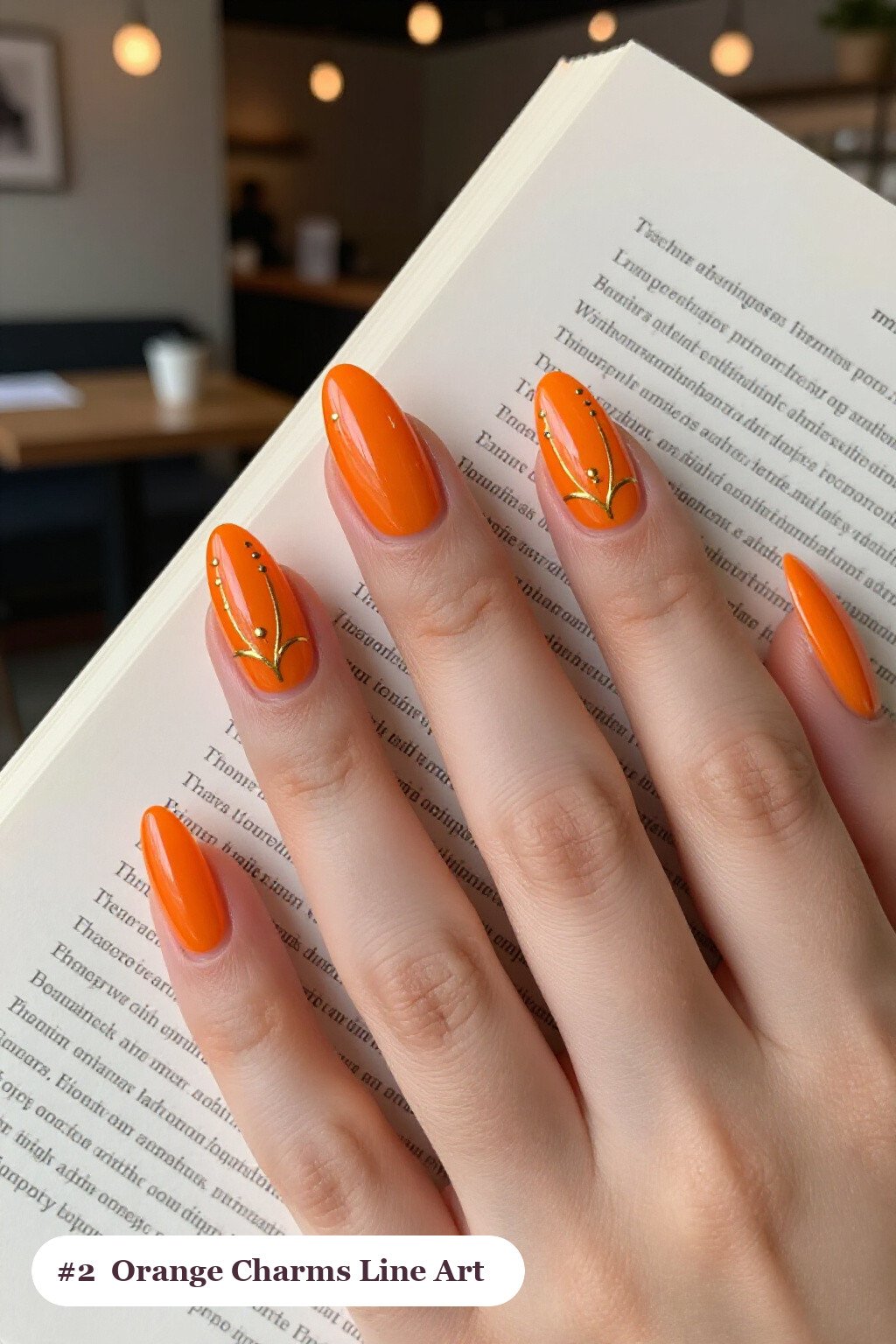 Medium almond orange charms nails with fine gold line art and tiny dots drawn across every nail, perfect for halloween - halloween nails with charms