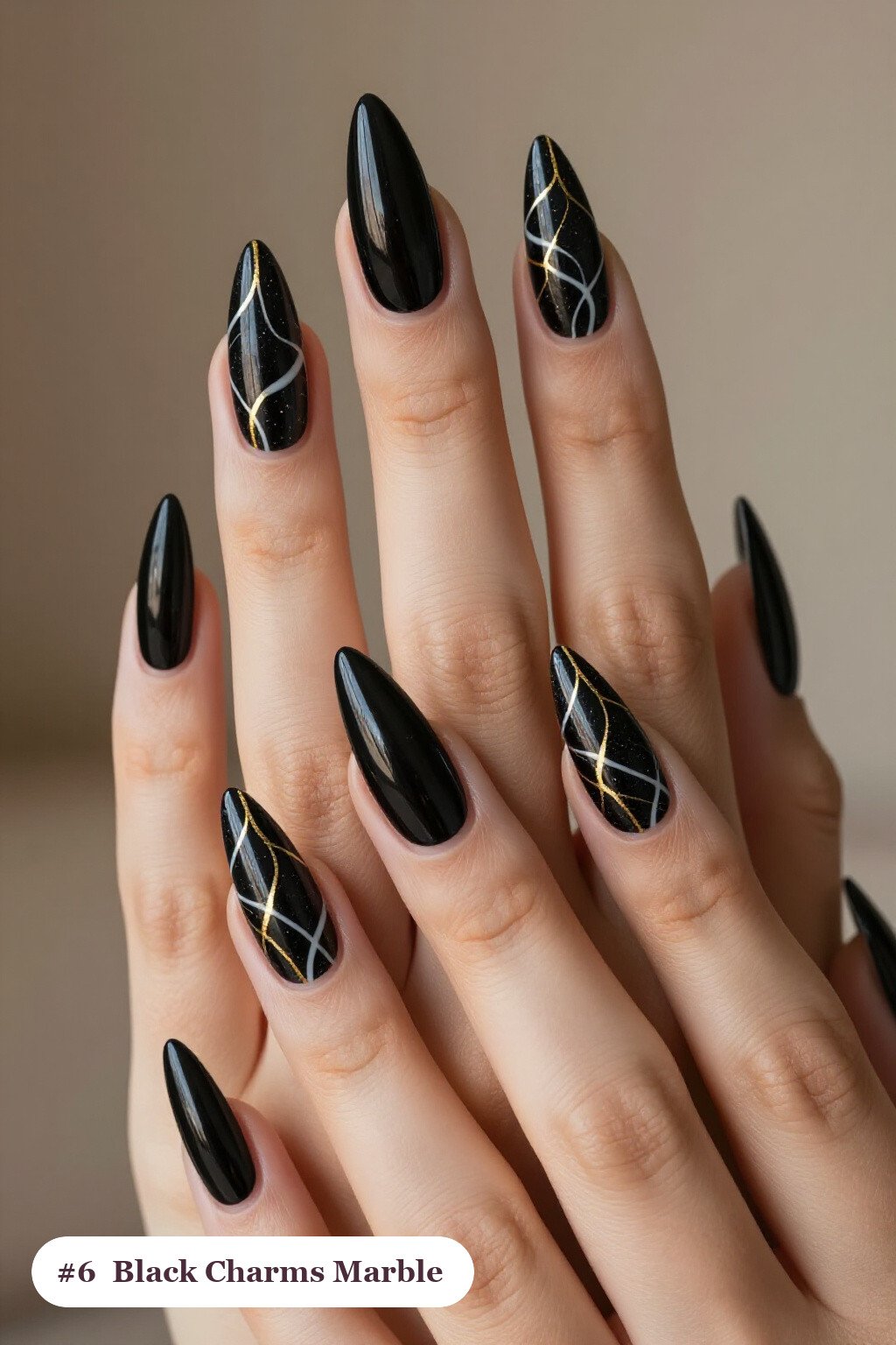 Long stiletto black charms nails with bold marble veins in white and gold across every nail, perfect for halloween - halloween nails with charms