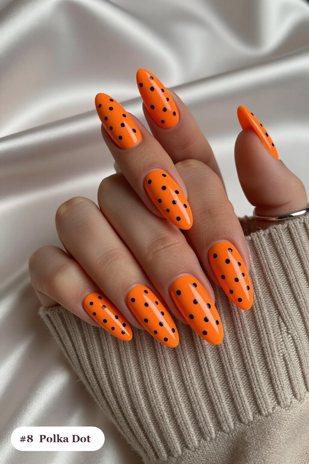 Long almond orange charms nails with playful polka dots in two colours on alternating nails, perfect for halloween - halloween nails with charms