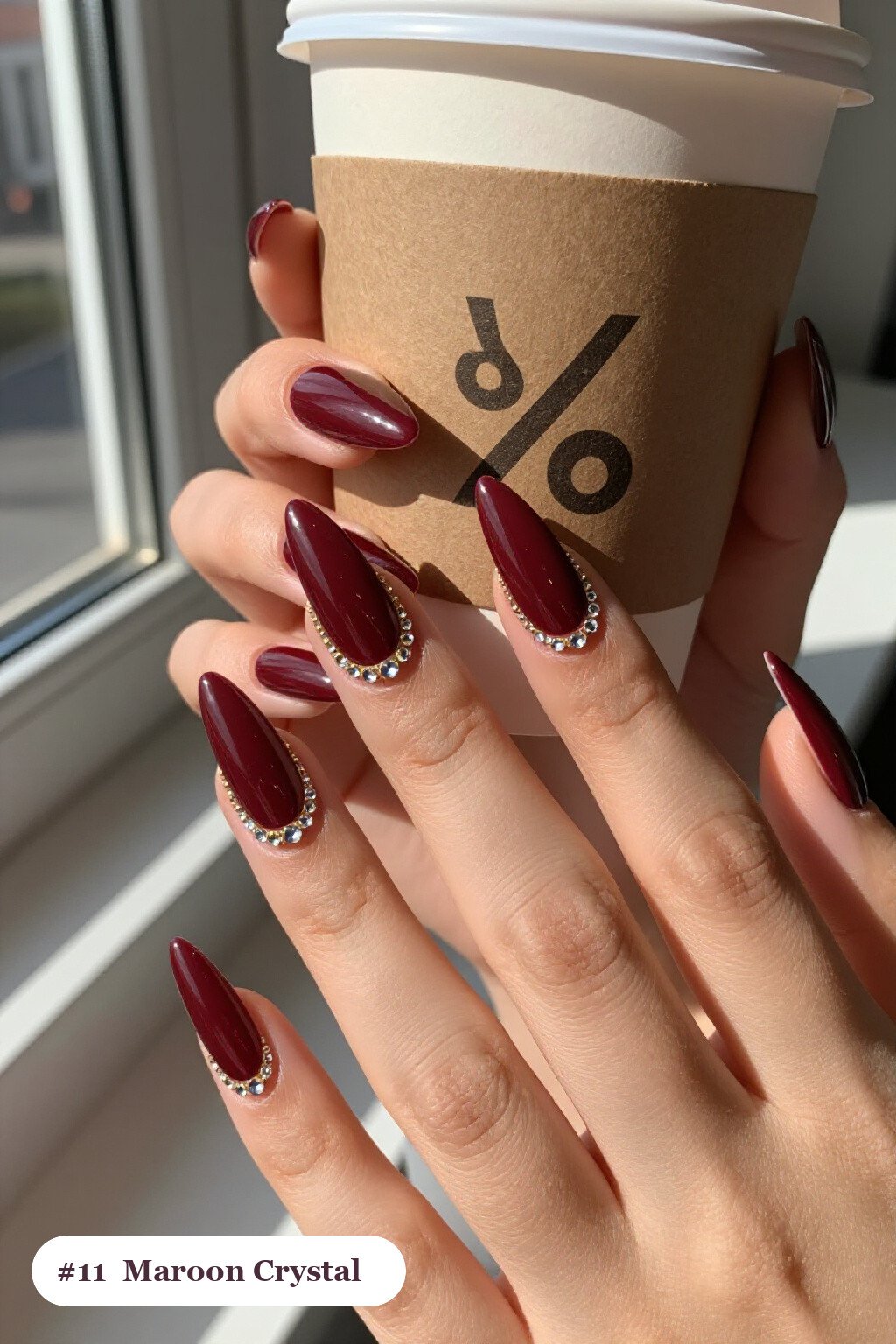 Long stiletto maroon nails with rows of sparkling crystal rhinestones along the cuticle of every nail, with gold details, perfect for fall - maroon fall nails Long stiletto maroon nails with rows of sparkling crystal rhinestones along the cuticle of every nail, with gold details, perfect for fall - maroon fall nails