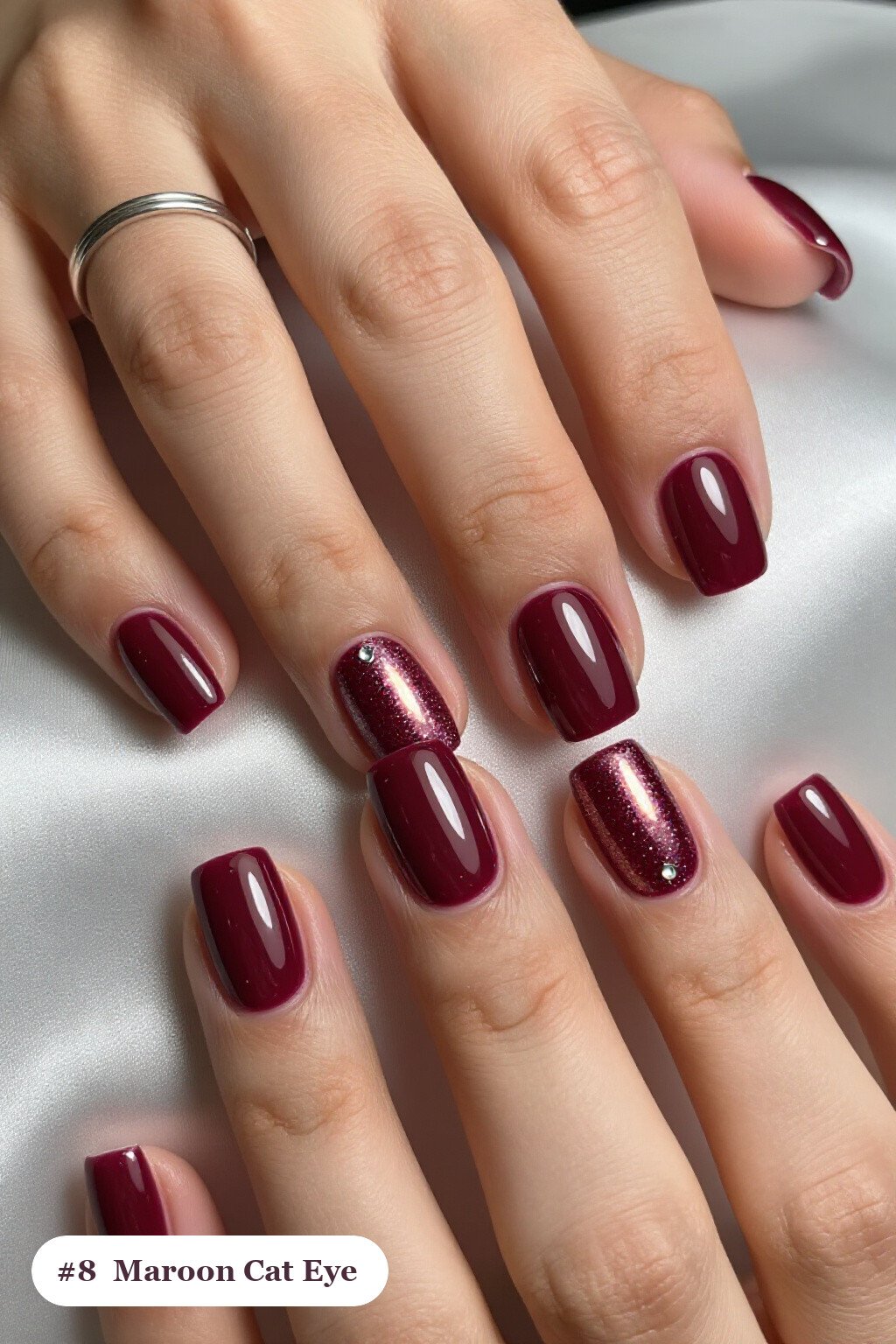 Short square maroon nails with a glowing shimmer band of light running down the centre of each nail like a gemstone, with silver details, perfect for fall - maroon fall nails Short square maroon nails with a glowing shimmer band of light running down the centre of each nail like a gemstone, with silver details, perfect for fall - maroon fall nails
