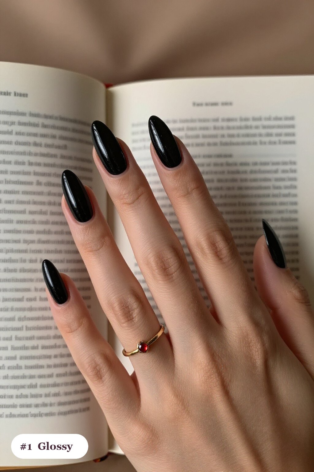 Long almond black minimalist nails in a flawless mirror-glossy full-colour finish, perfect for halloween - minimalist halloween nails