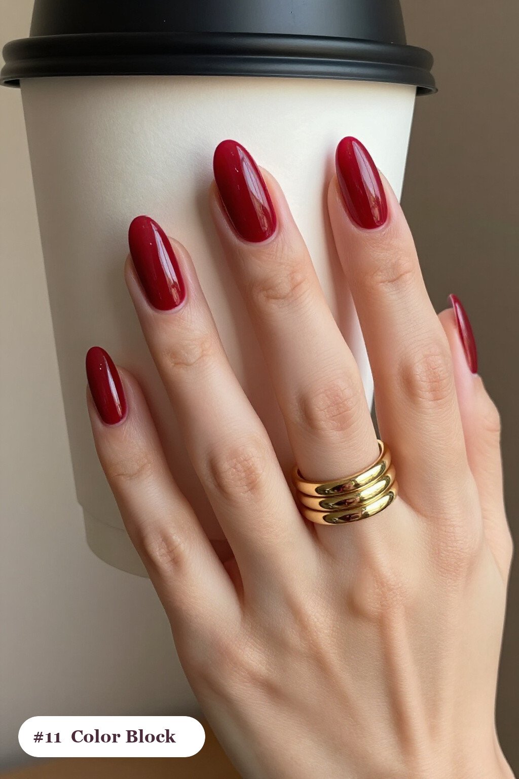 Long almond blood red minimalist nails in a colour-block design split diagonally with a thin gold line, perfect for halloween - minimalist halloween nails