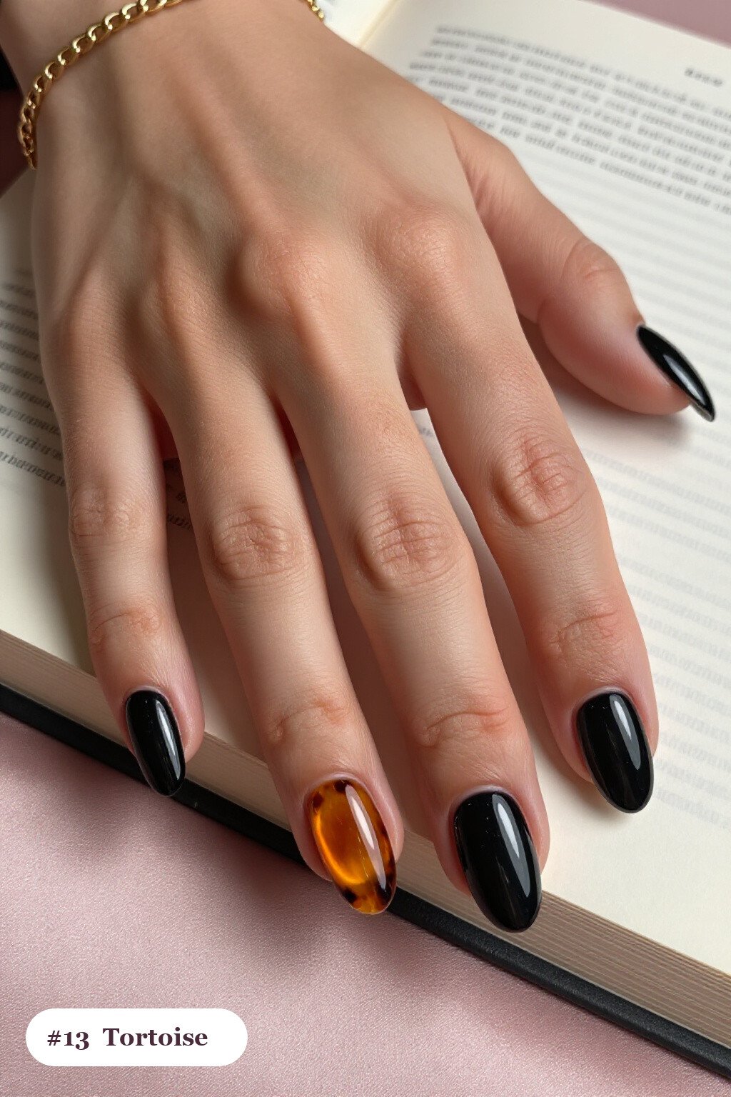 Medium oval black minimalist nails with glossy amber tortoiseshell on two accent nails, perfect for halloween - minimalist halloween nails