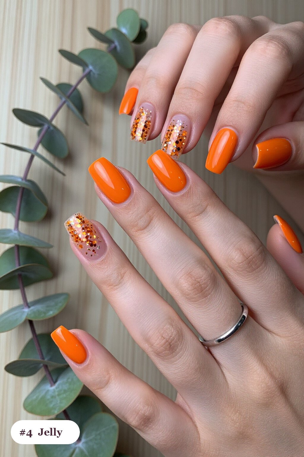 Medium square orange minimalist nails in a see-through jelly finish with encapsulated glitter, perfect for halloween - minimalist halloween nails