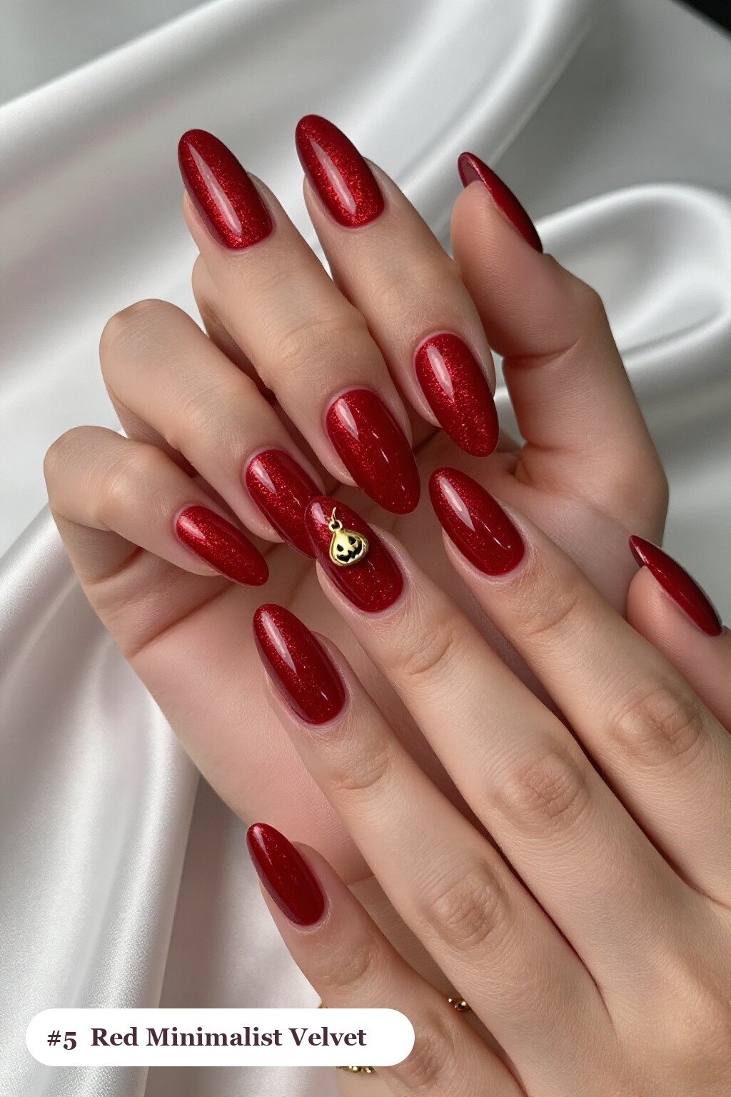 Long coffin blood red minimalist nails in a velvet shimmer finish with one glossy accent nail with a gold charm, perfect for halloween - minimalist halloween nails