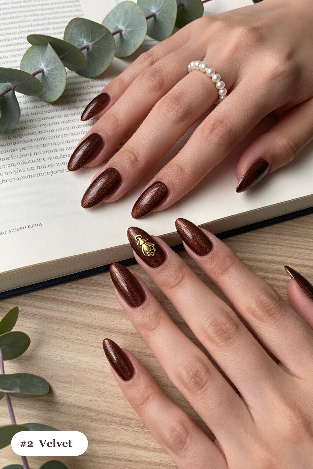 Long almond chocolate brown october november nails in a velvet shimmer finish with one glossy accent nail with a gold charm - october november nail designs
