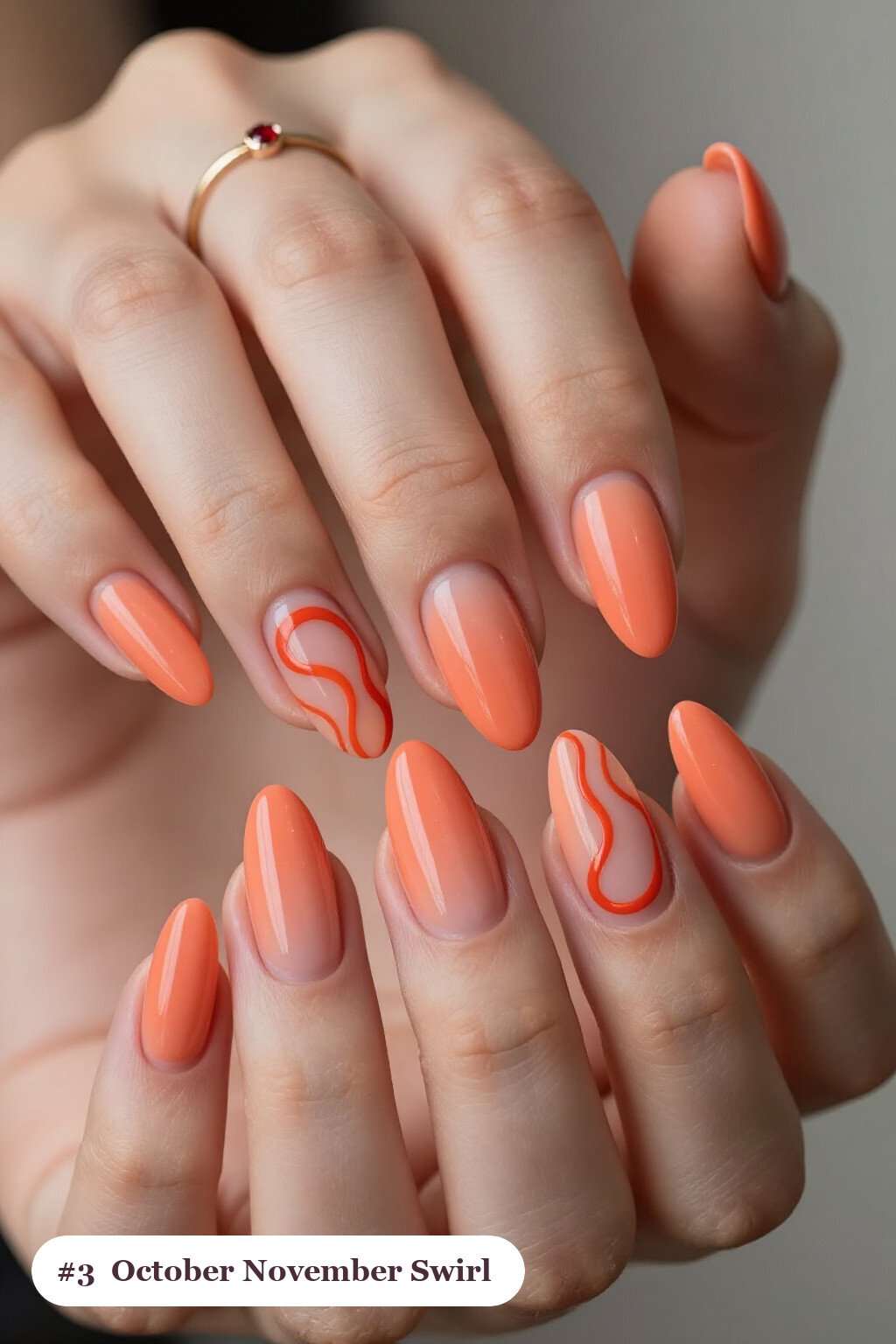 Long stiletto coral october november nails with bold hand-painted swirl lines flowing across every nail in a contrasting colour - october november nail designs