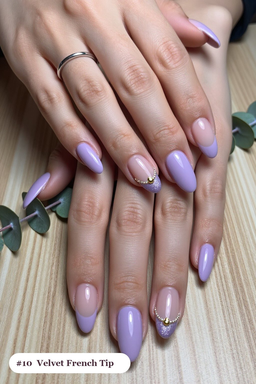 Medium almond lavender ombre french nails with crisp french tips and a smooth ombre gradient clearly visible on every nail, styled with a velvet shimmer finish with one glossy accent nail with a gold charm - ombre french almond nails