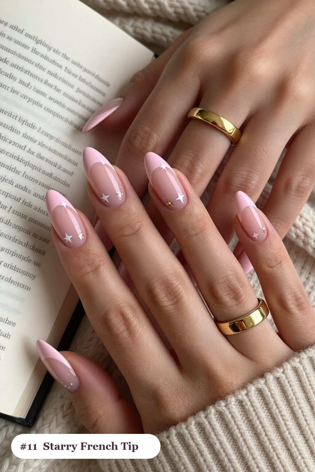 Medium almond baby pink ombre french nails with crisp french tips and a smooth ombre gradient clearly visible on every nail, styled with white and gold stars and sparkles painted on every nail - ombre french almond nails