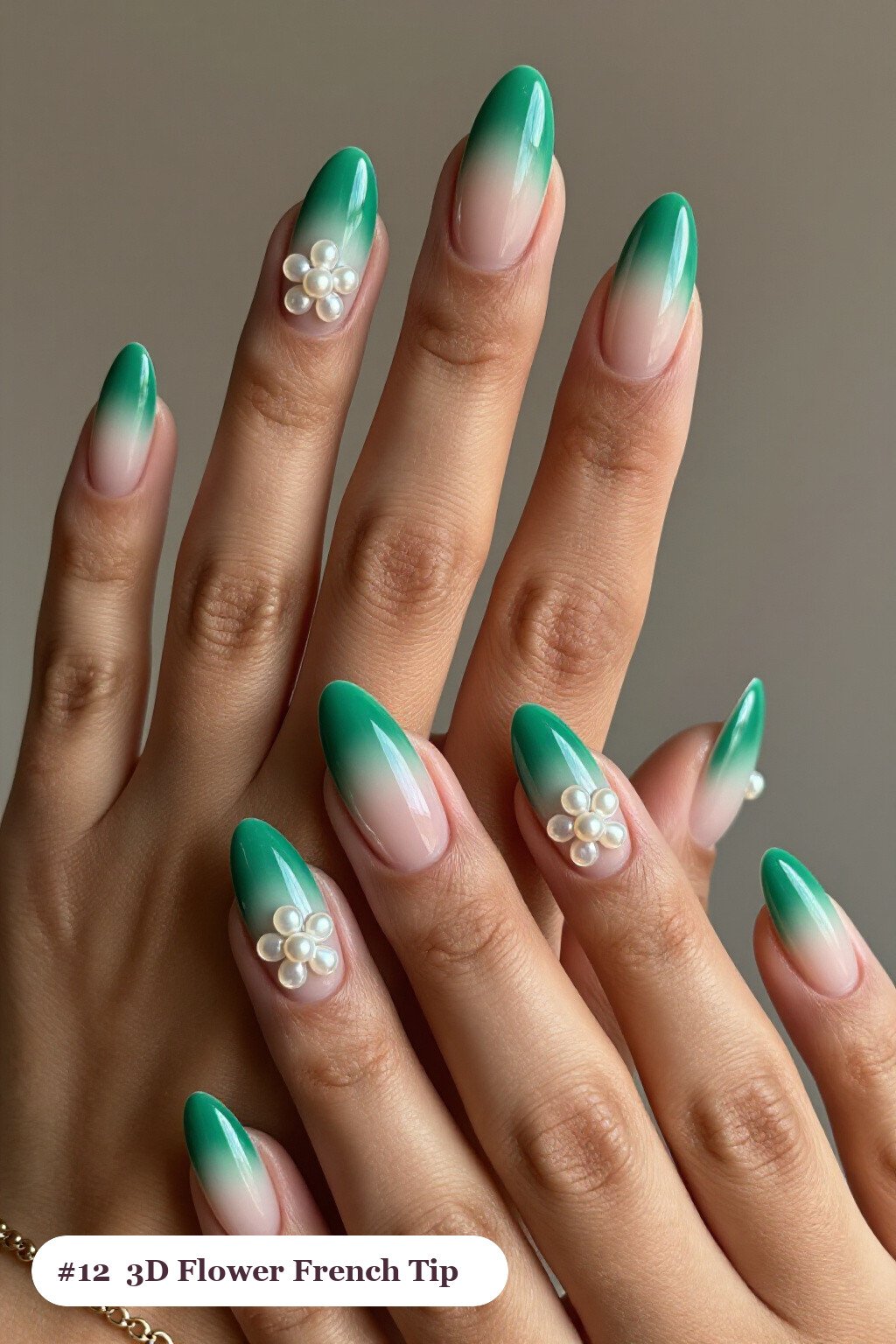 Medium almond emerald green ombre french nails with crisp french tips and a smooth ombre gradient clearly visible on every nail, styled with raised 3D flowers with pearl centres on two accent nails - ombre french almond nails