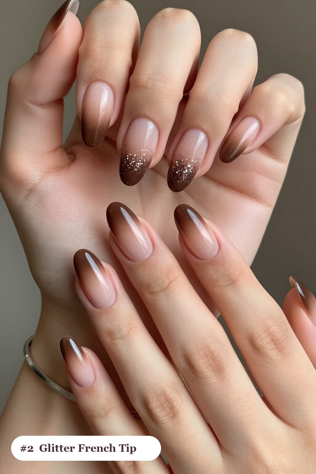 Medium almond chocolate brown ombre french nails with crisp french tips and a smooth ombre gradient clearly visible on every nail, styled with a sparkling glitter gradient rising from the cuticle - ombre french almond nails