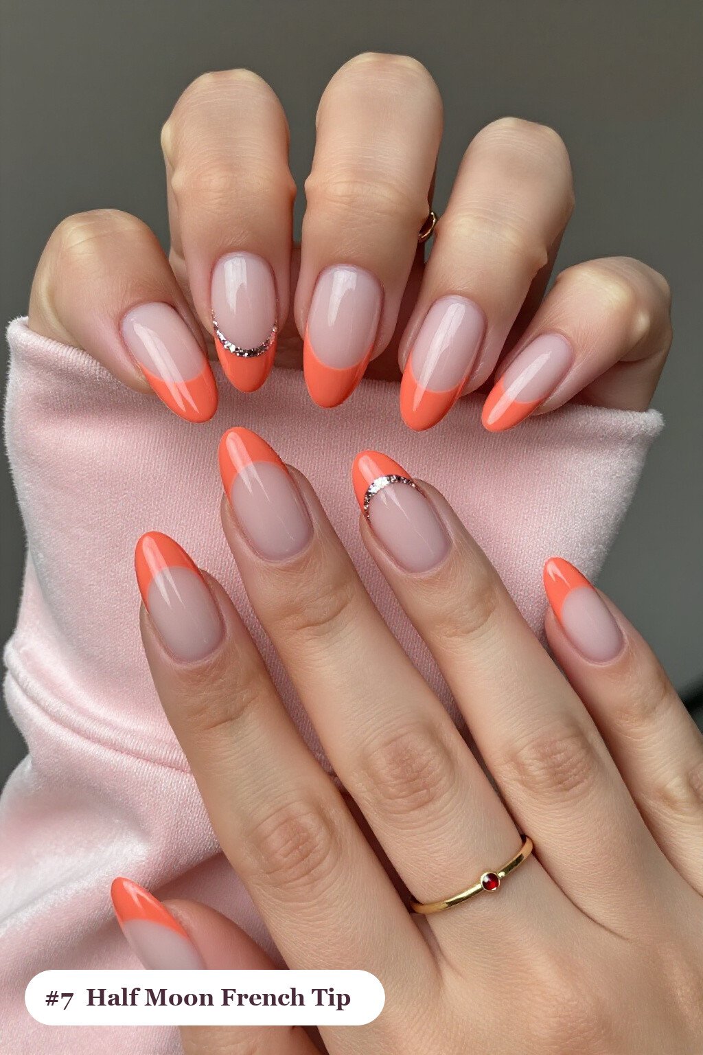 Medium almond coral ombre french nails with crisp french tips and a smooth ombre gradient clearly visible on every nail, styled with a half-moon design with a glitter crescent at the cuticle - ombre french almond nails