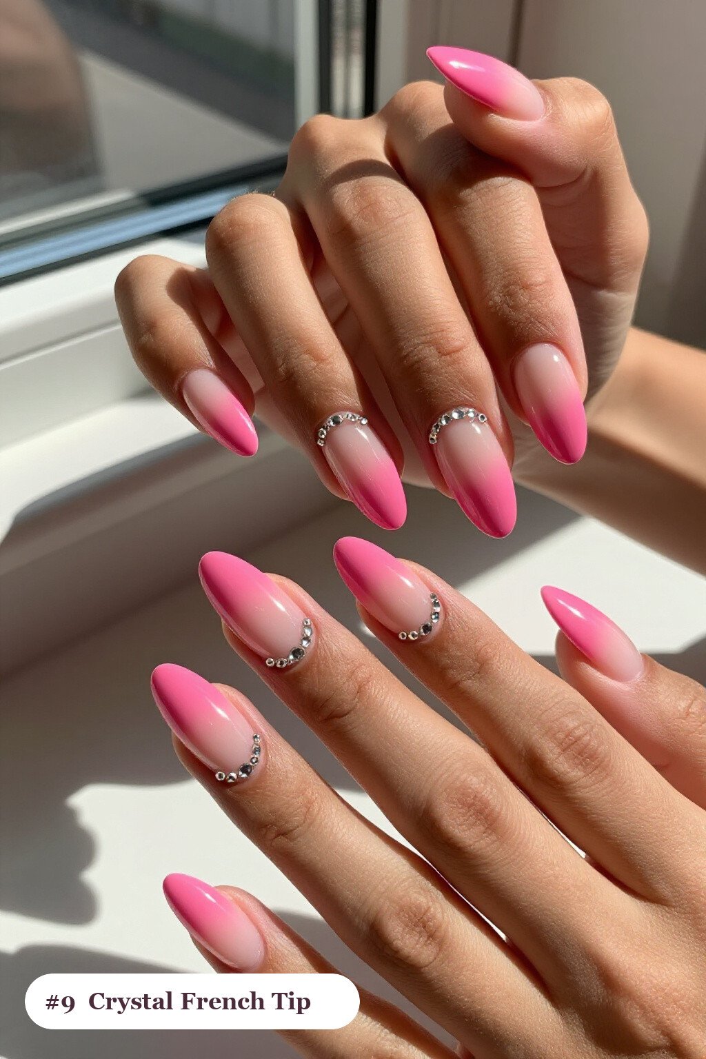 Medium almond hot pink ombre french nails with crisp french tips and a smooth ombre gradient clearly visible on every nail, styled with rows of sparkling crystal rhinestones along the cuticle of every nail - ombre french almond nails