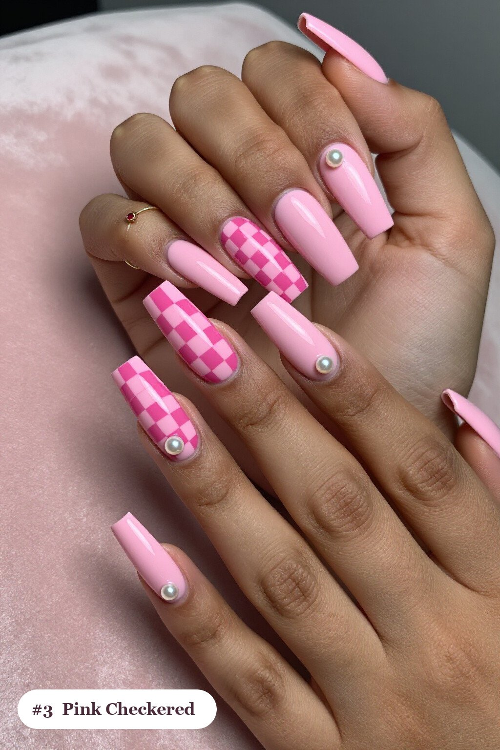 Long square pink nails with a bold checkerboard pattern on two accent nails and solid colour on the rest, with pearl details - pink nails Long square pink nails with a bold checkerboard pattern on two accent nails and solid colour on the rest, with pearl details - pink nails
