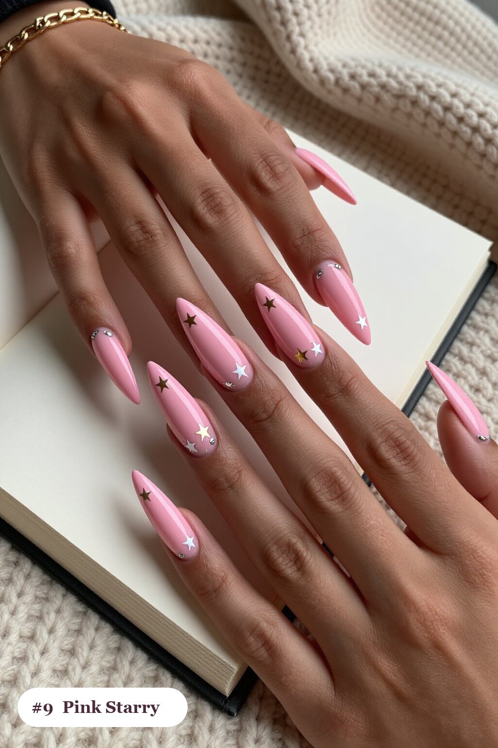 Long stiletto pink nails with white and gold stars and sparkles painted on every nail, with silver chrome details - pink nails Long stiletto pink nails with white and gold stars and sparkles painted on every nail, with silver chrome details - pink nails