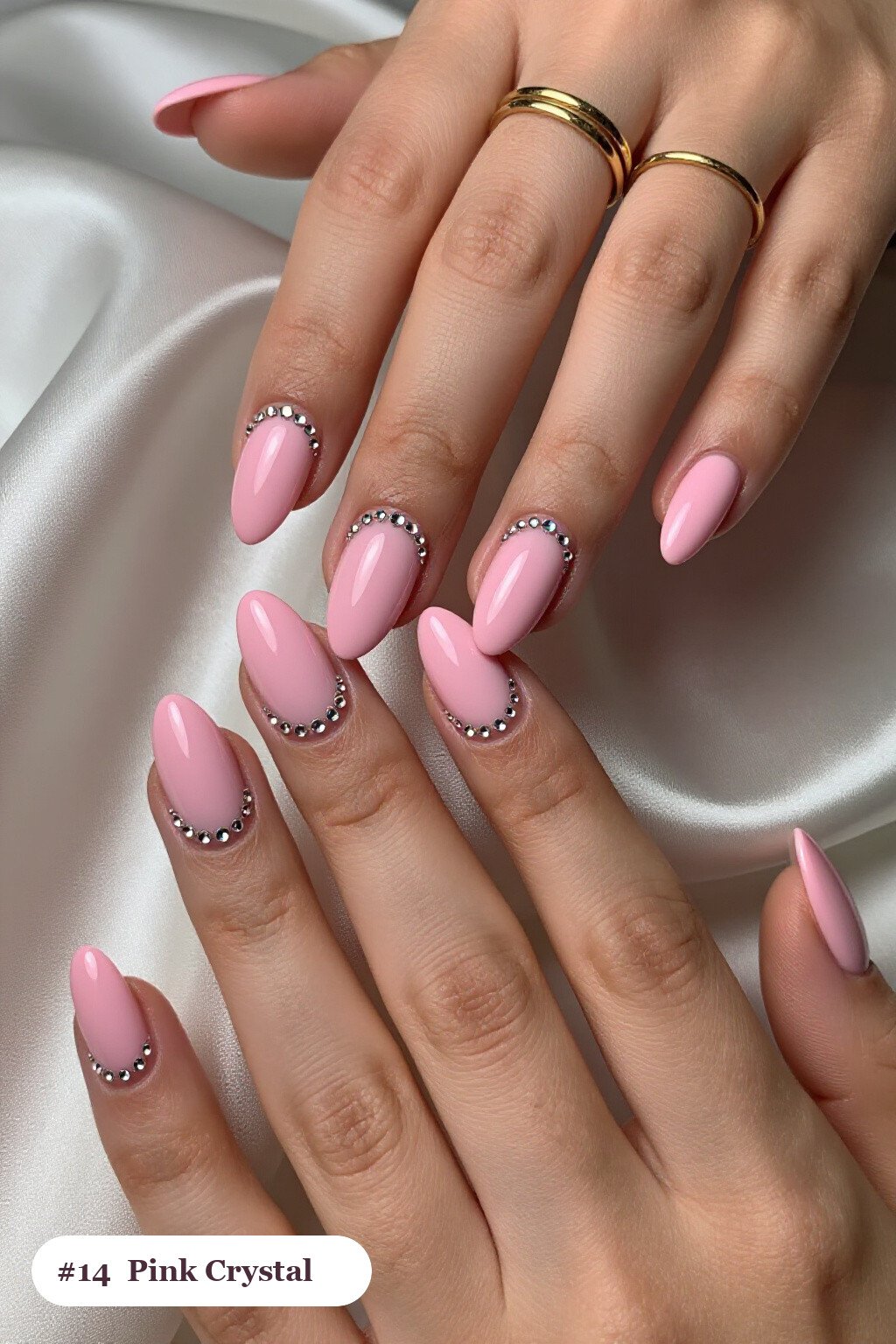 Medium almond pink nails with rows of sparkling crystal rhinestones along the cuticle of every nail, with champagne details - pink nails almond