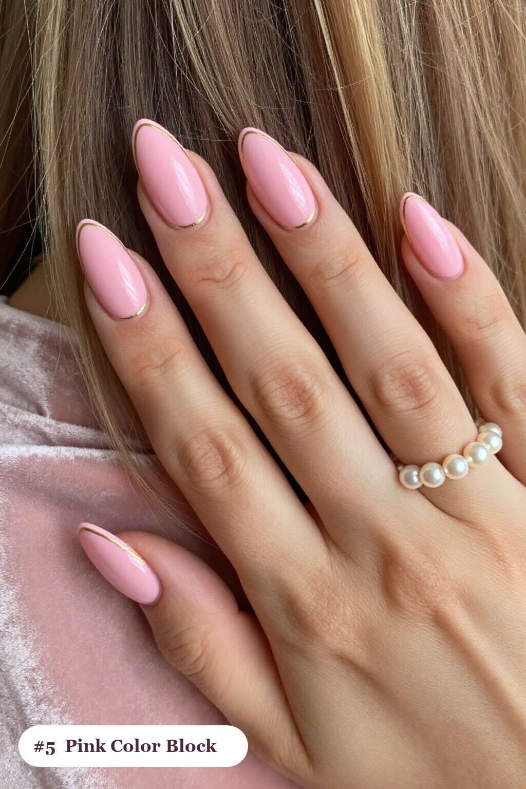 Medium almond pink nails in a colour-block design split diagonally with a thin gold line, with gold details - pink nails almond