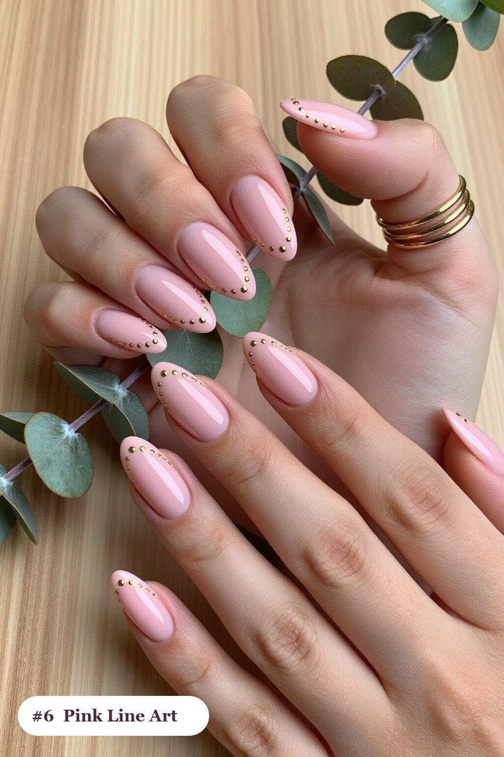Medium almond pink nails with fine gold line art and tiny dots drawn across every nail, with champagne details - pink nails almond