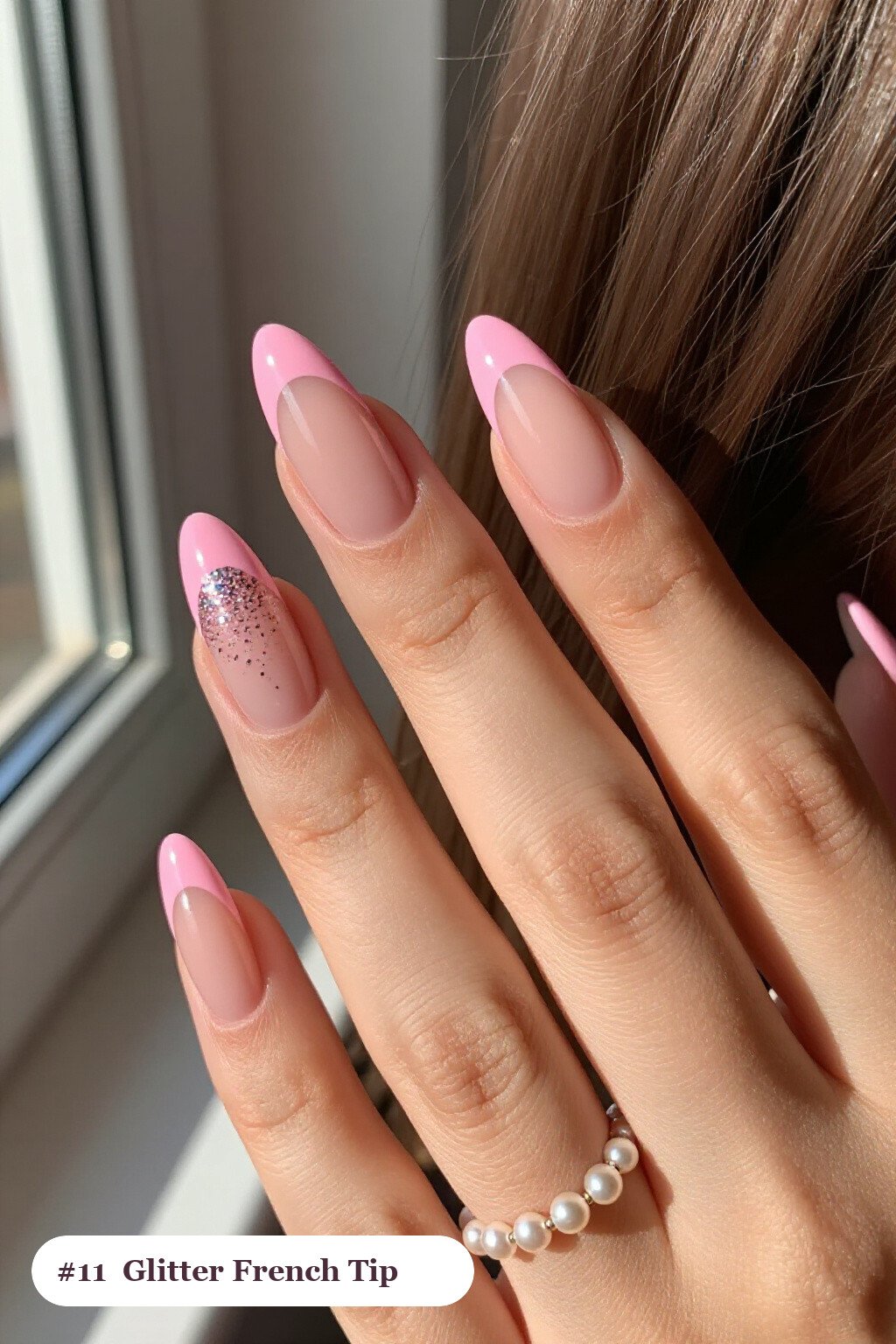 Medium almond pink french tip nails with crisp french tips clearly visible on every nail, styled with a sparkling glitter gradient rising from the cuticle, with soft nude details - pink nails almond french tip