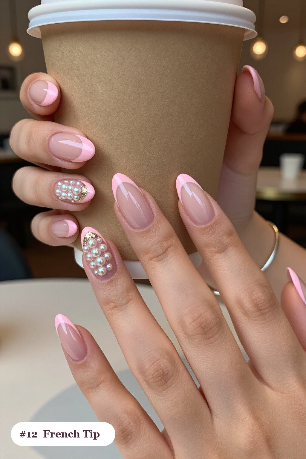 Medium almond pink french tip nails with crisp french tips clearly visible on every nail, styled with glazed pearl chrome over the colour for an iridescent sheen, with champagne details - pink nails almond french tip