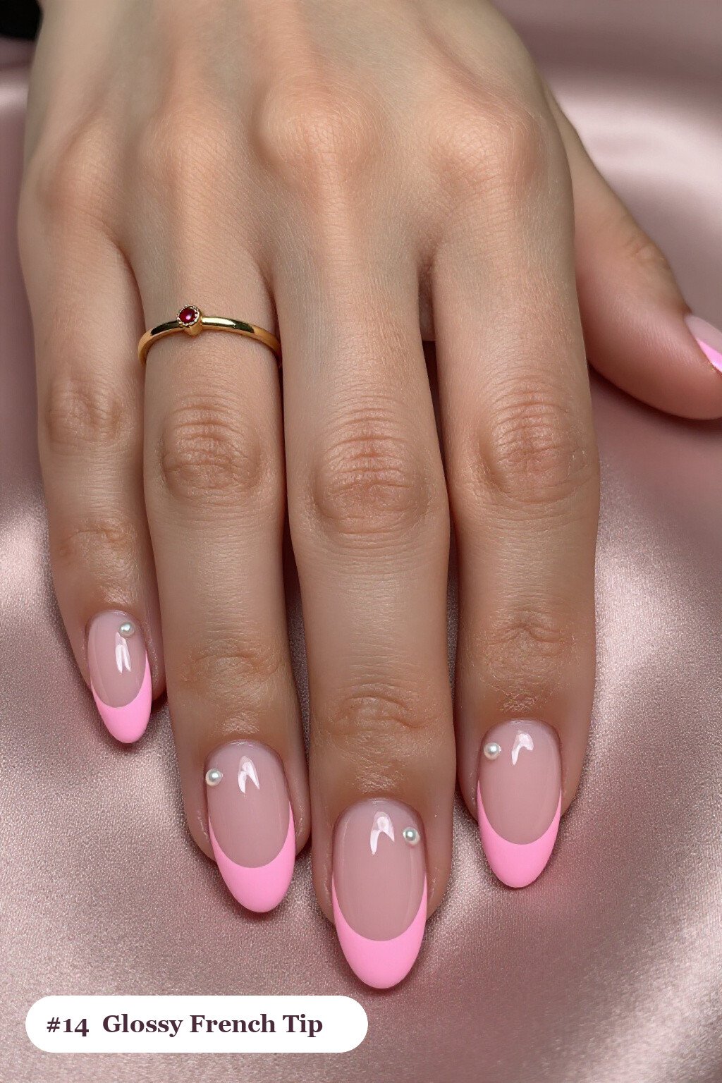Medium almond pink french tip nails with crisp french tips clearly visible on every nail, styled with a flawless mirror-glossy full-colour finish, with pearl details - pink nails almond french tip