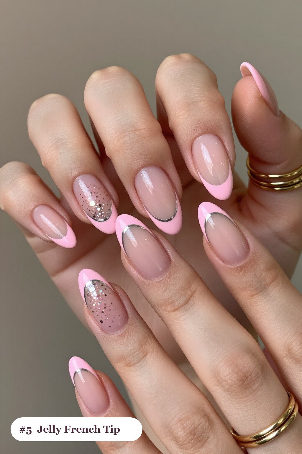 Medium almond pink french tip nails with crisp french tips clearly visible on every nail, styled with a see-through jelly finish with encapsulated glitter, with silver chrome details - pink nails almond french tip