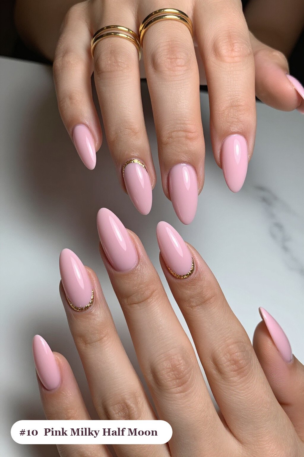 Long Almond Pink Milky Nails with Half‑Moon Glitter Crescent and Gold Details - pink nails milky