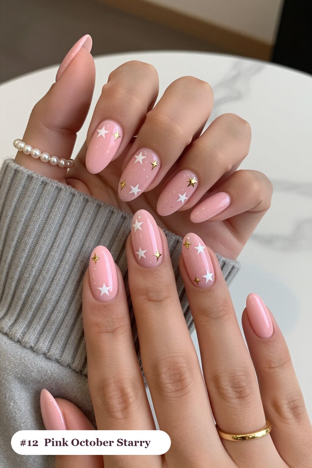 Medium almond pink october nails with white and gold stars and sparkles painted on every nail, with gold details - pink october nail designs Medium almond pink october nails with white and gold stars and sparkles painted on every nail, with gold details - pink october nail designs