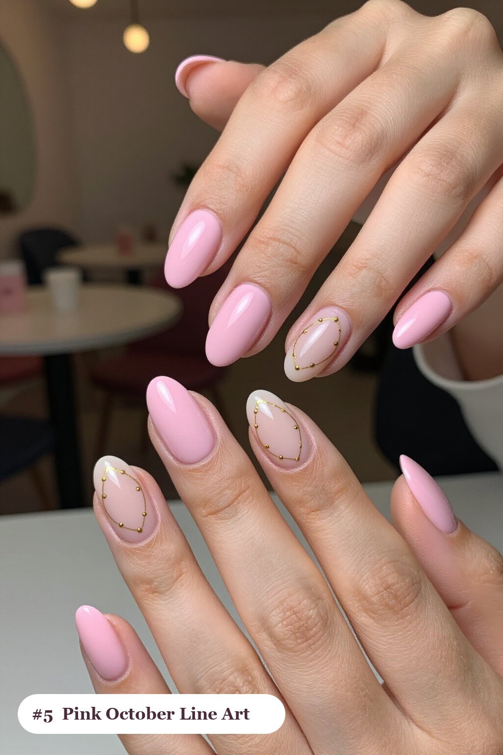 Medium oval pink october nails with fine gold line art and tiny dots drawn across every nail, with soft nude details - pink october nail designs Medium oval pink october nails with fine gold line art and tiny dots drawn across every nail, with soft nude details - pink october nail designs