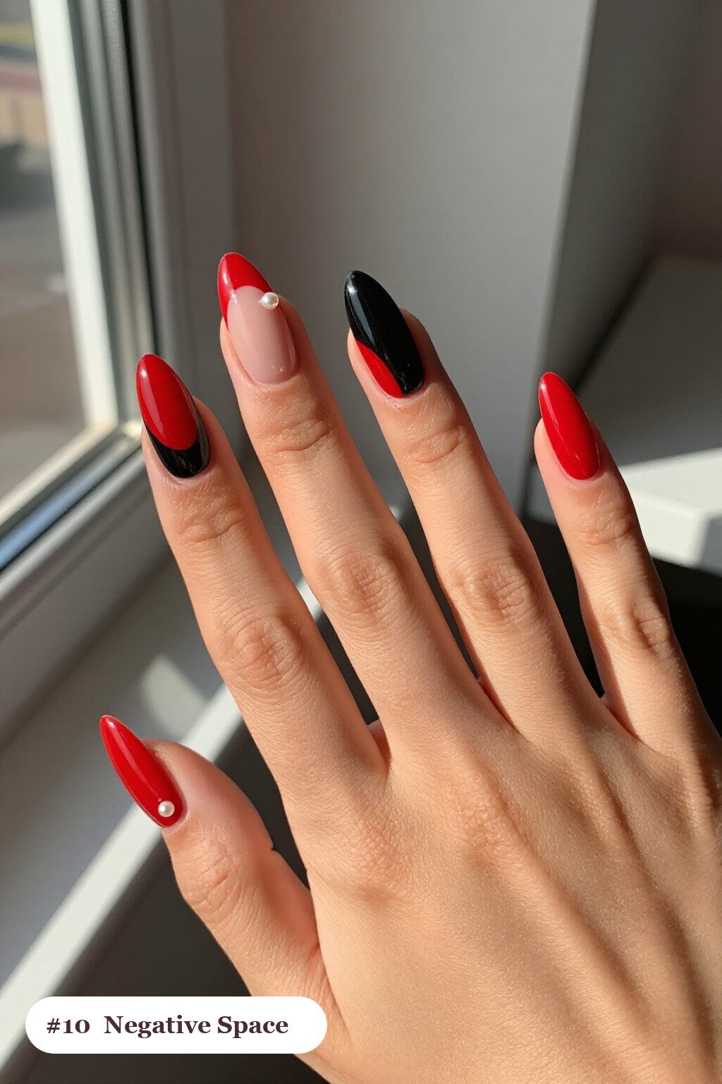 Long coffin red black nails in a negative-space design with sheer nude windows and bold colour shapes, with pearl details - red and black nails