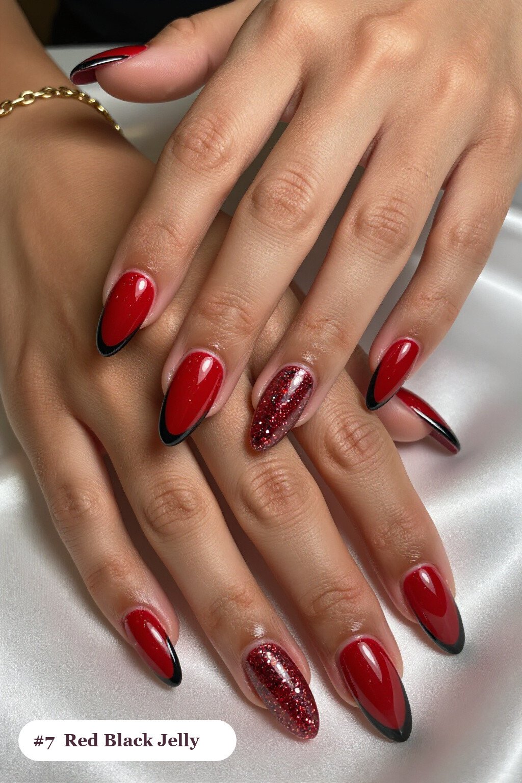 Medium almond red black nails in a see-through jelly finish with encapsulated glitter, with silver details - red and black nails