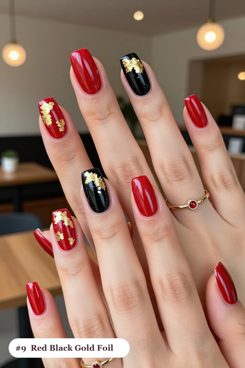 Long square red black nails with dense gold foil flakes and gold leaf scattered across every nail, with silver chrome details - red and black nails