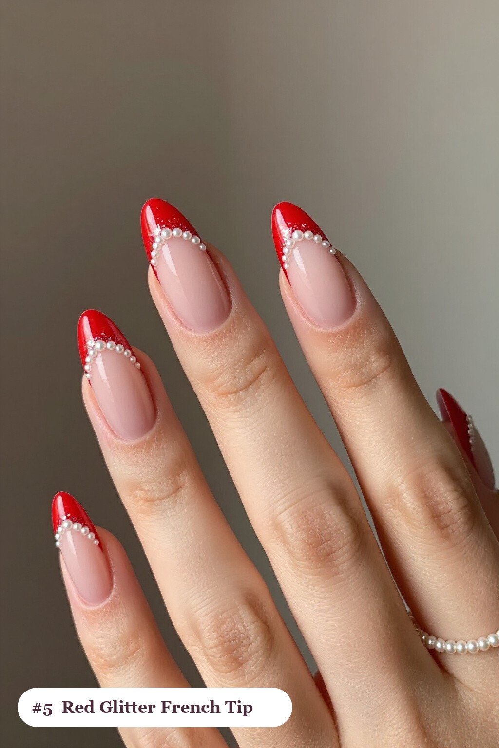 Medium coffin red french nails with crisp french tips clearly visible on every nail, styled with a sparkling glitter gradient rising from the cuticle, with pearl details - red french nails Medium coffin red french nails with crisp french tips clearly visible on every nail, styled with a sparkling glitter gradient rising from the cuticle, with pearl details - red french nails
