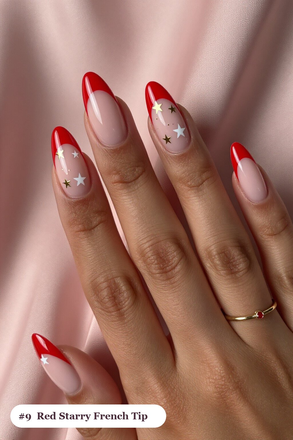 Medium almond red french nails with crisp french tips clearly visible on every nail, styled with white and gold stars and sparkles painted on every nail, with gold details - red french nails Medium almond red french nails with crisp french tips clearly visible on every nail, styled with white and gold stars and sparkles painted on every nail, with gold details - red french nails