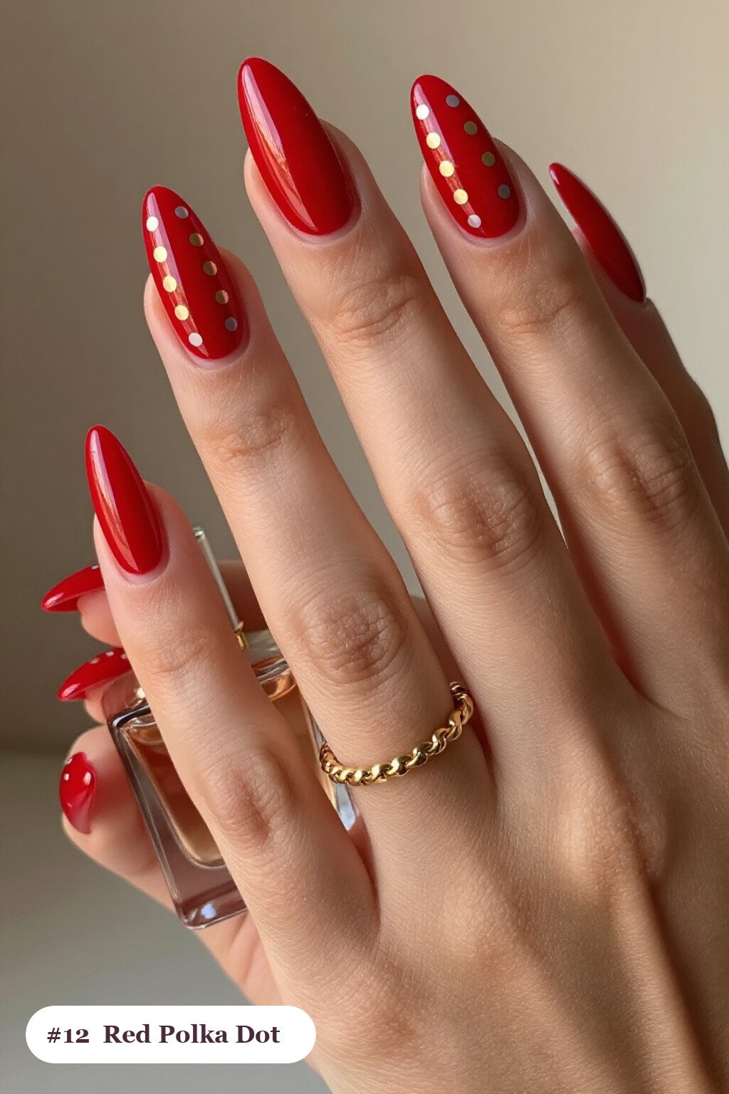 Long almond red nails with playful polka dots in two colours on alternating nails, with champagne details - red nails