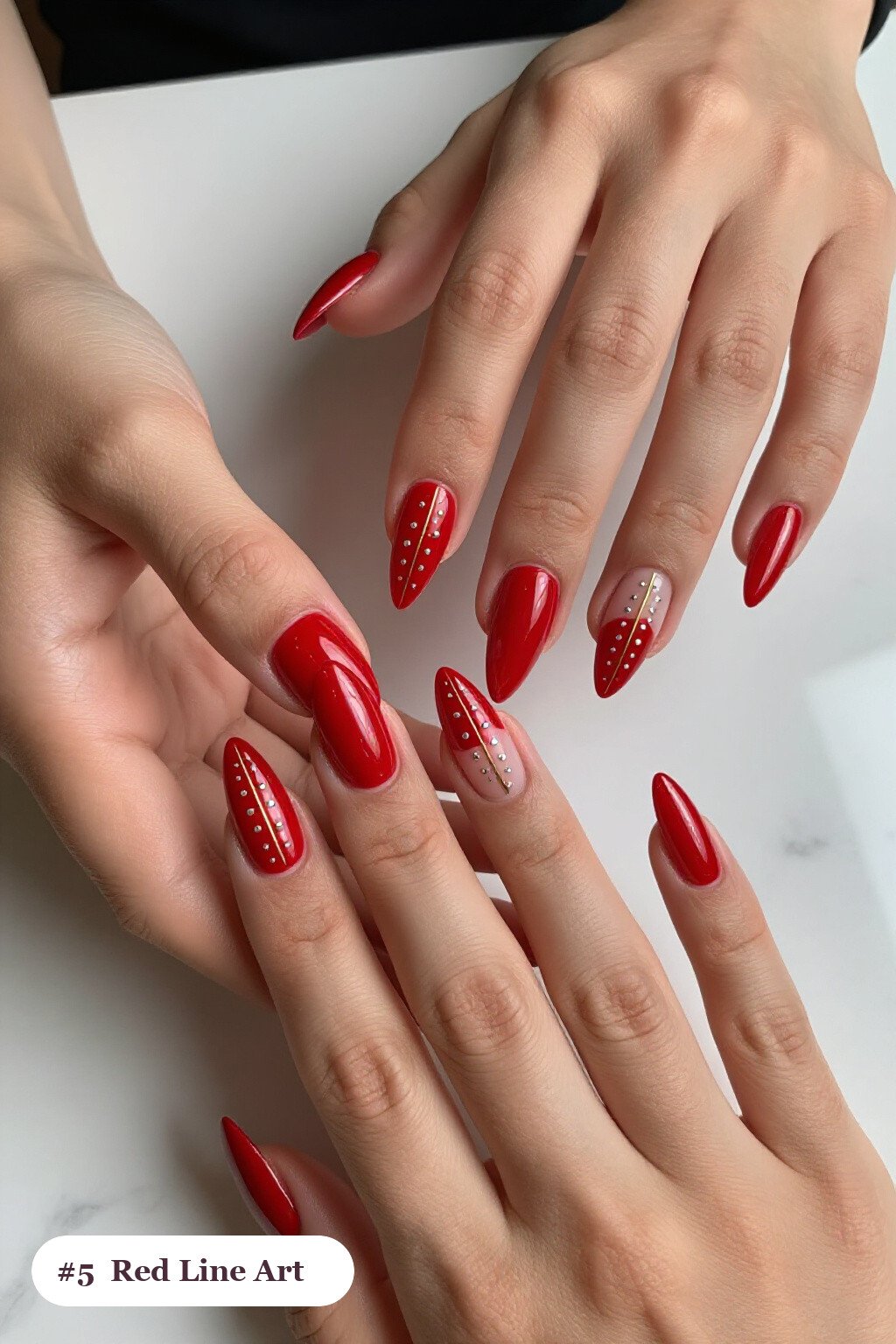Long stiletto red nails with fine gold line art and tiny dots drawn across every nail, with silver details - red nails