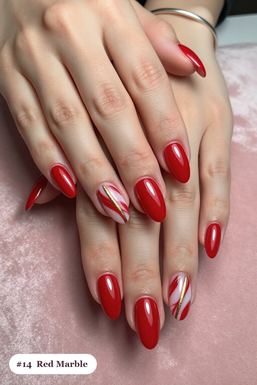 Medium almond red nails with bold marble veins in white and gold across every nail, with gold details - red nails almond