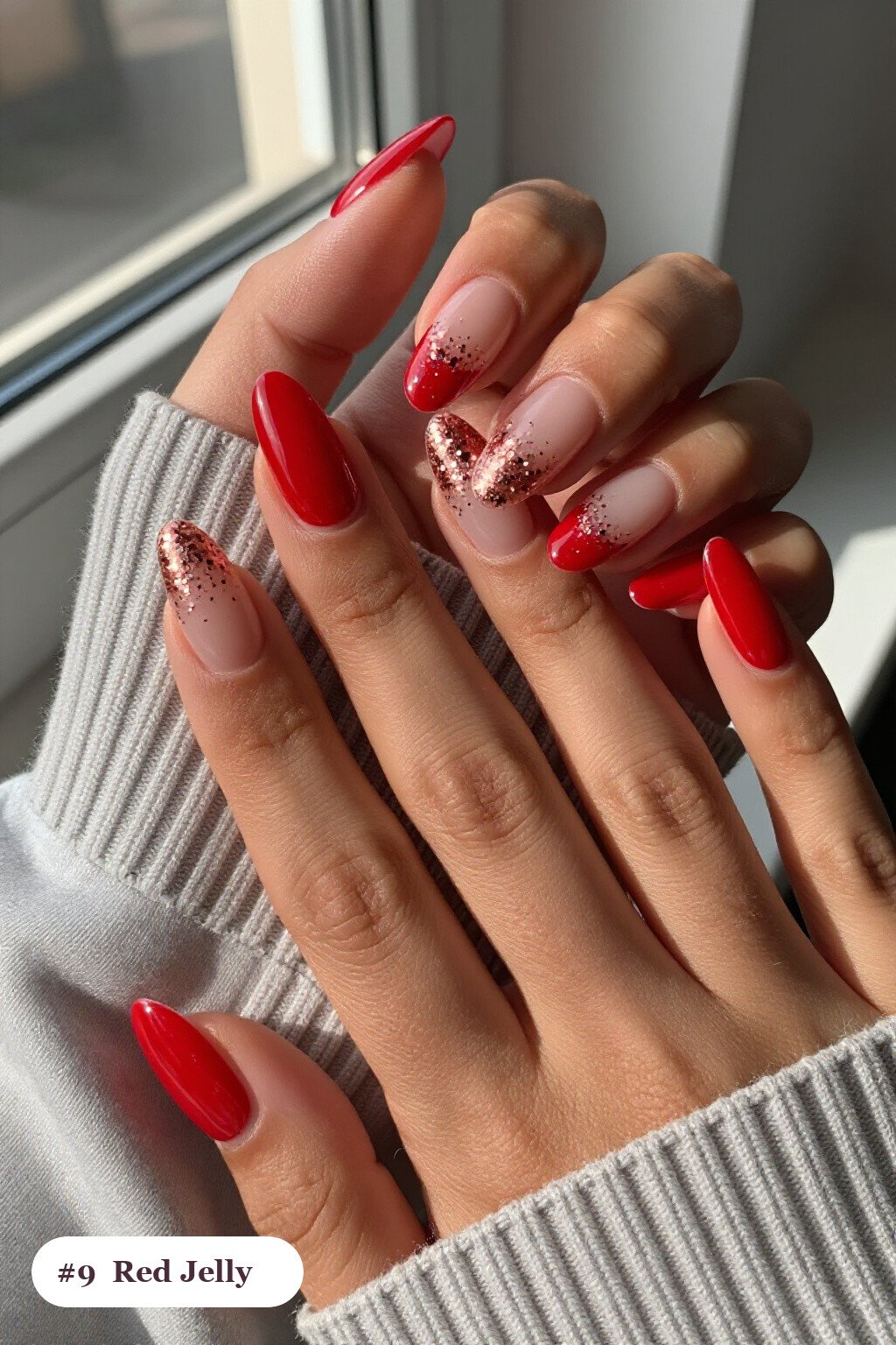 Medium almond red nails in a see-through jelly finish with encapsulated glitter, with rose gold details - red nails almond