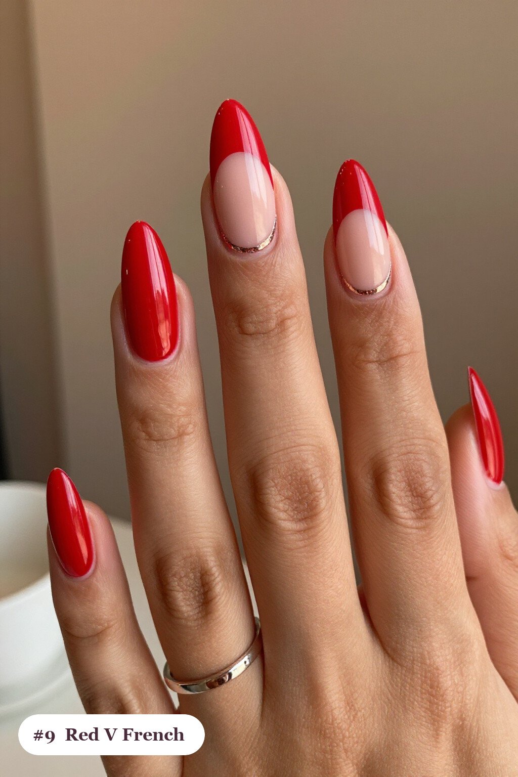 Almond Red Nails Featuring Deep V‑French Tips and Rose Gold Accents - red nails holiday Almond Red Nails Featuring Deep V‑French Tips and Rose Gold Accents - red nails holiday