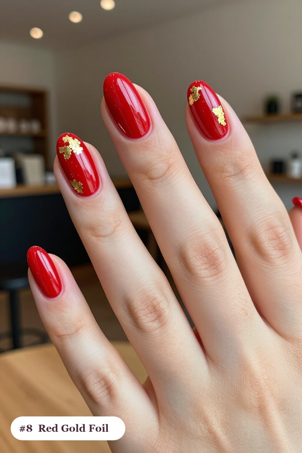 Dense Gold Foil Flakes and Leaf Scattered Across Almond Red Nails with Gold Details - red nails short