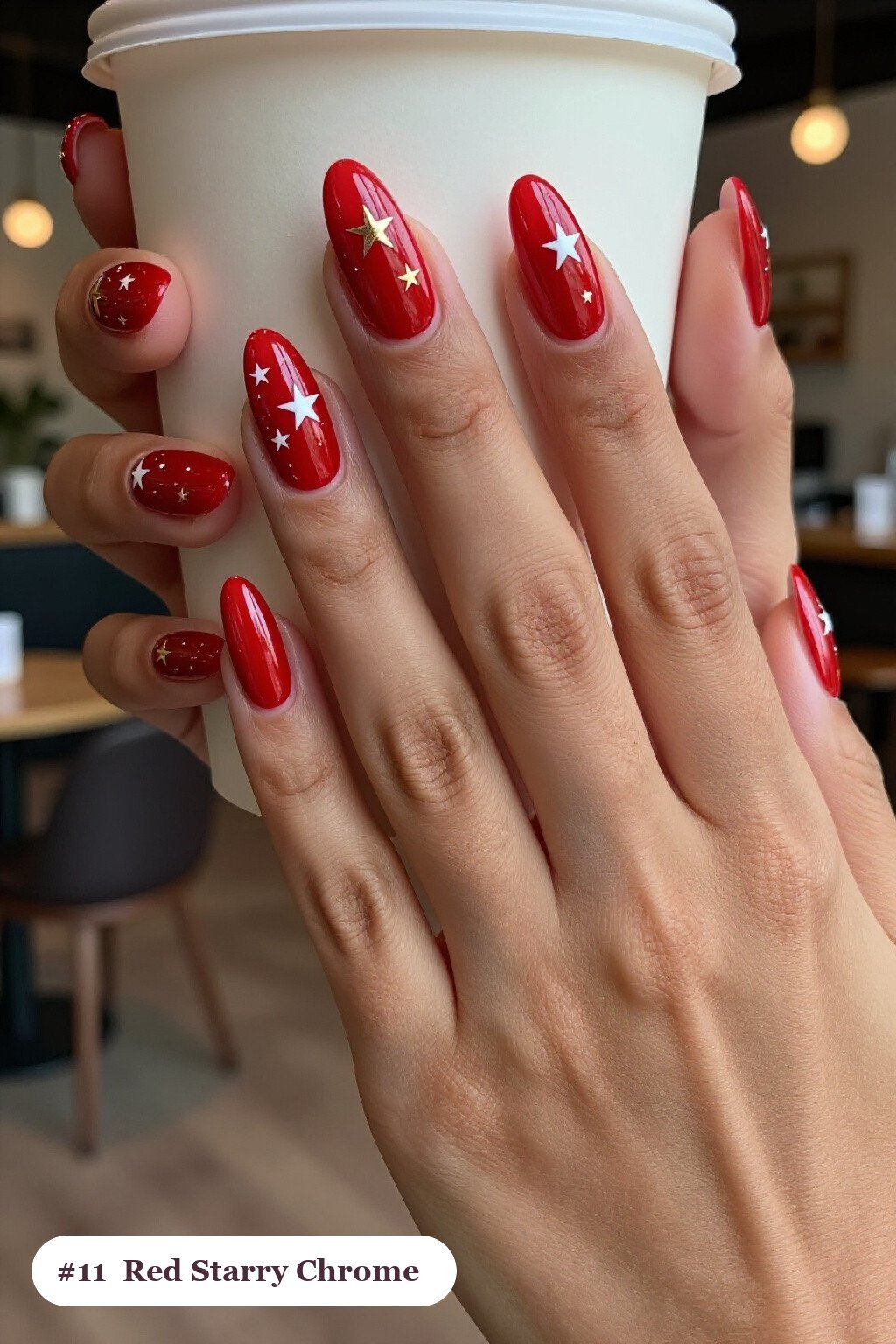 Medium coffin red chrome nails with a liquid chrome mirror finish clearly visible on every nail, styled with white and gold stars and sparkles painted on every nail, with rose gold details - red nails with chrome Medium coffin red chrome nails with a liquid chrome mirror finish clearly visible on every nail, styled with white and gold stars and sparkles painted on every nail, with rose gold details - red nails with chrome
