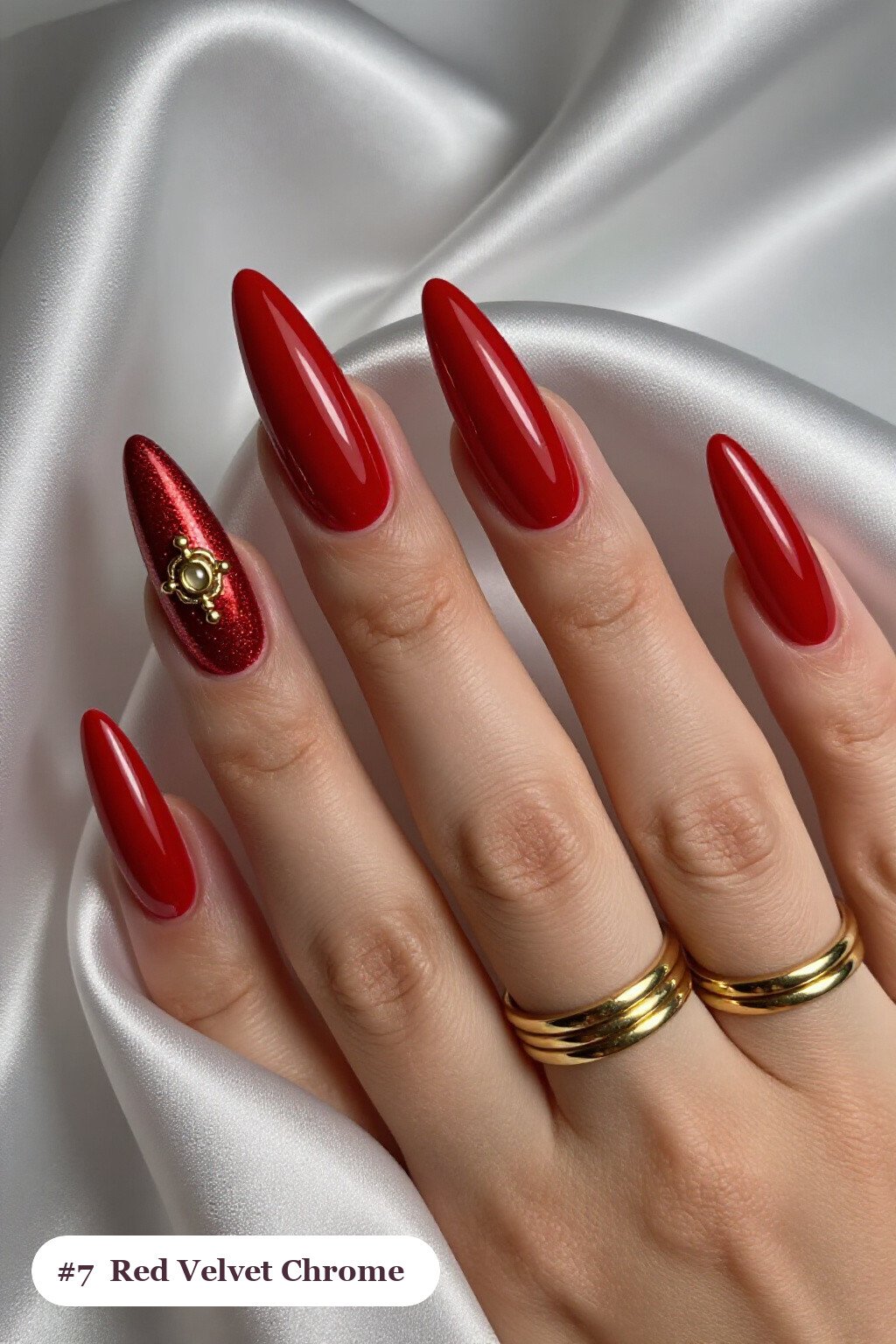 Long stiletto red chrome nails with a liquid chrome mirror finish clearly visible on every nail, styled with a velvet shimmer finish with one glossy accent nail with a gold charm, with gold details - red nails with chrome Long stiletto red chrome nails with a liquid chrome mirror finish clearly visible on every nail, styled with a velvet shimmer finish with one glossy accent nail with a gold charm, with gold details - red nails with chrome